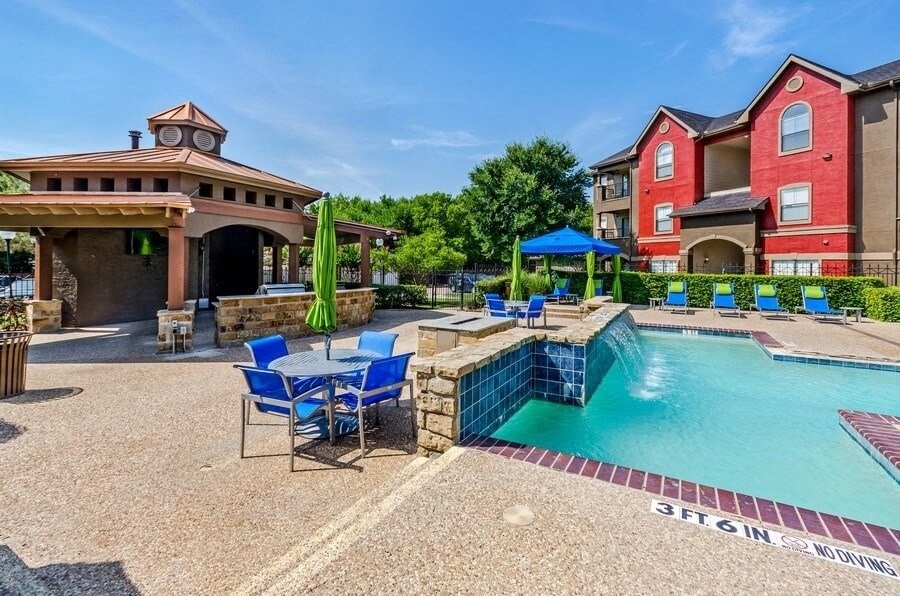 Swimming pool with cabanas and lounge chairs at Hidden Creek, Lewisville, Texas