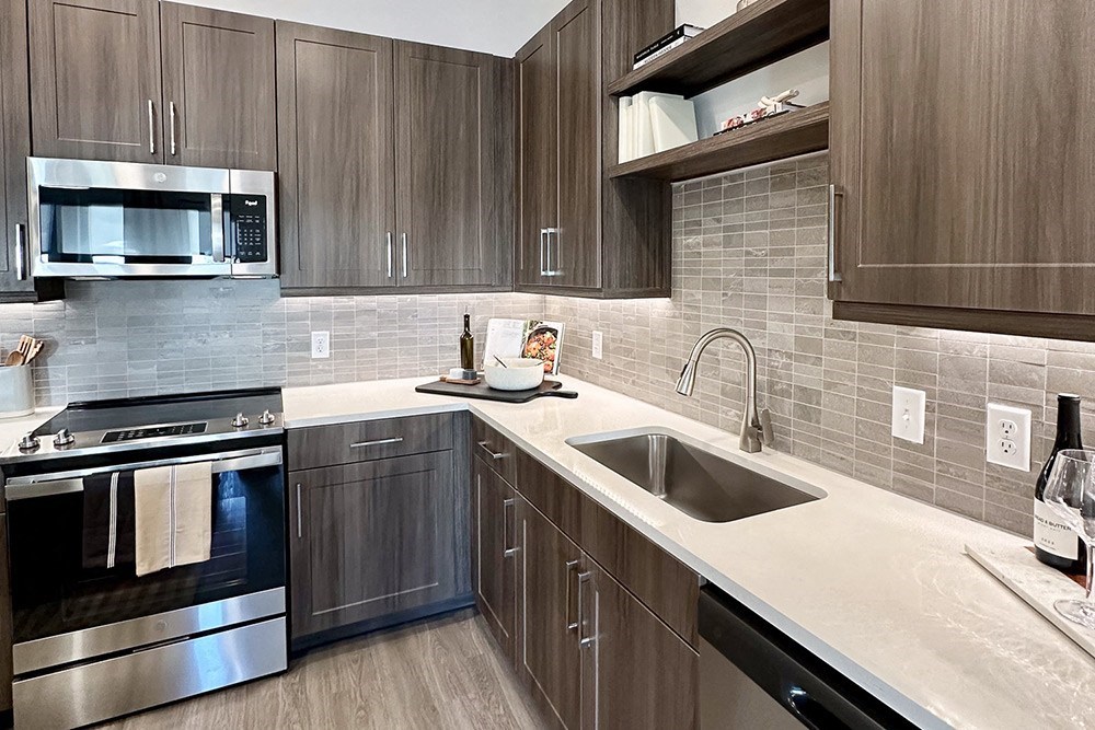 a rendering of a kitchen with wood cabinets and a sink