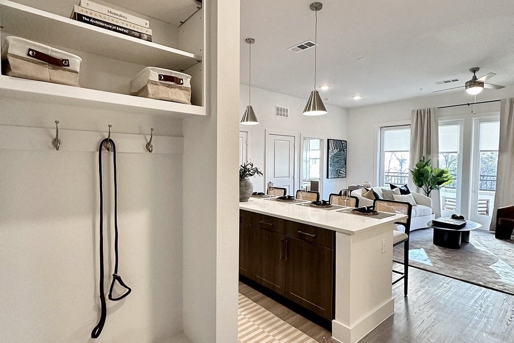 a view of a kitchen and living room from behind a bar
