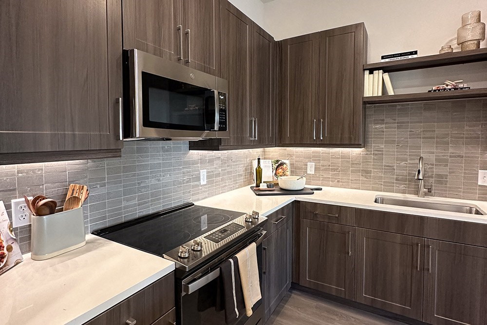 a kitchen with wooden cabinets and a stove and a microwave