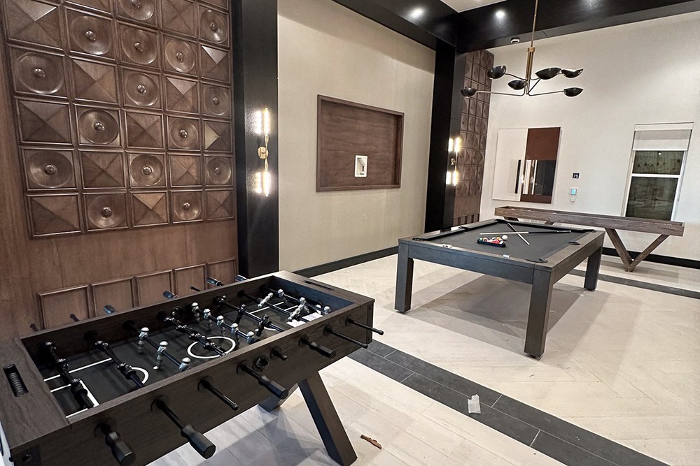 a game room with a ping pong table and a bar