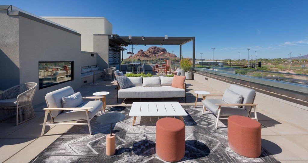 Rooftop lounge with chairs and fireplace