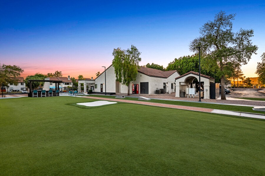 a yard with a golf course and a house in the background at Lore South Mountain, Phoenix, AZ