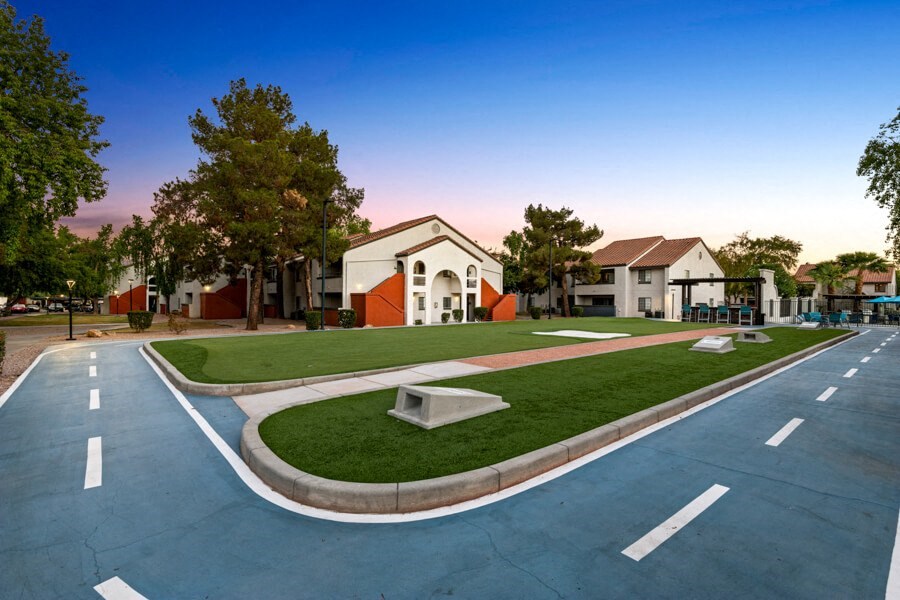 an empty parking lot with a building in the background at Lore South Mountain, Phoenix, 85044