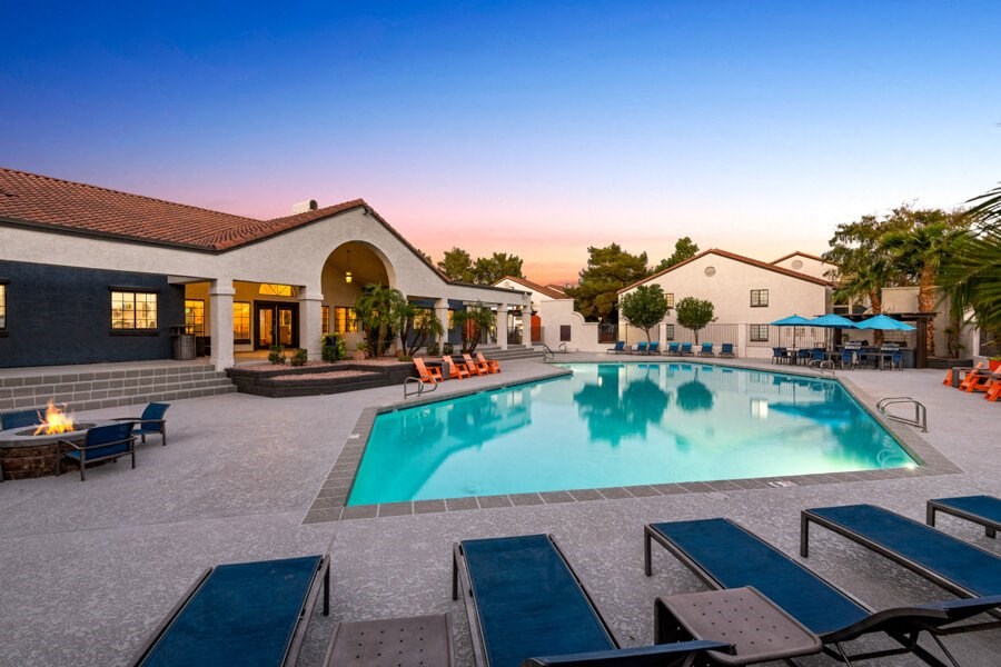 a swimming pool with lounge chairs around it in front of a building at Lore South Mountain, Phoenix, AZ, 85044