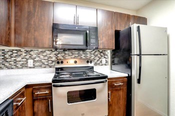 Model kitchen with stainless steel stove and over the range microwave - Photo Gallery 7