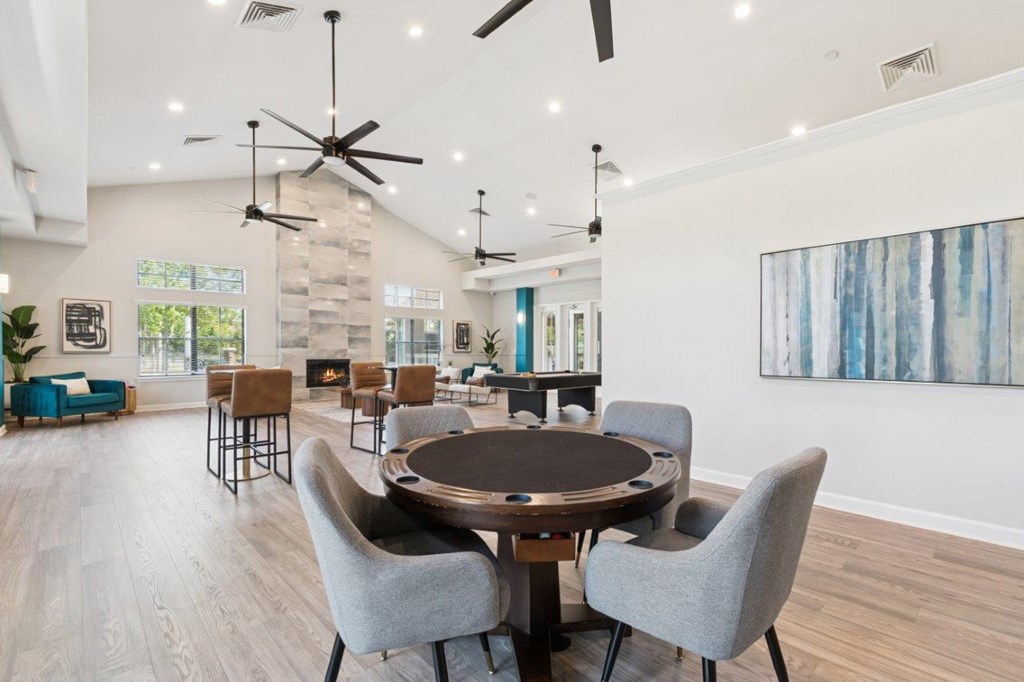 Community lounge with tables at Mirage on Kernan Apartments in Jacksonville, FL