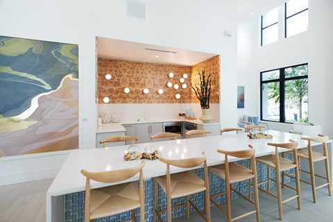 A kitchen with a white table and chairs.