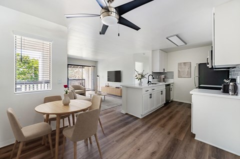 A modern kitchen with a dining table and chairs.
