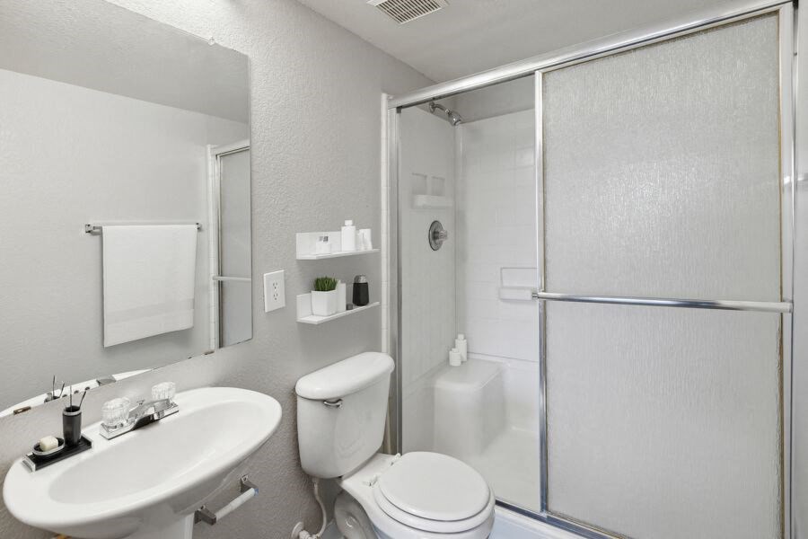a bathroom with a sink toilet and a shower