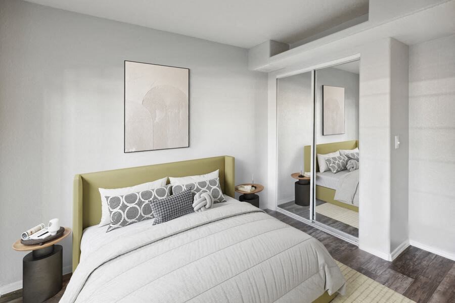a bedroom with a large bed and a mirror