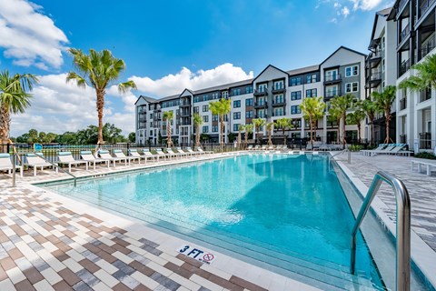 Community swimming pool and apartment side views at The Brooke at Rocky Point in Tampa, Florida.
