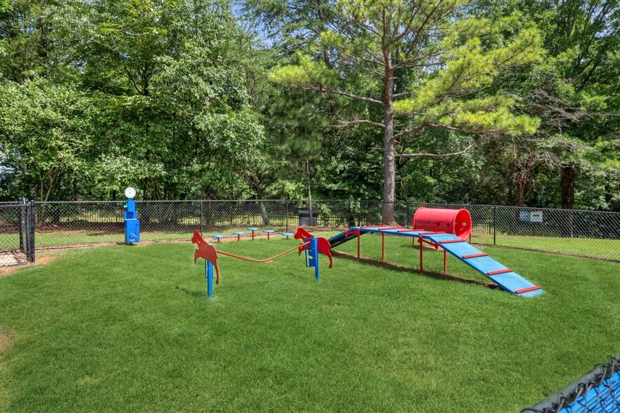 a playground with a slide and agility ropes