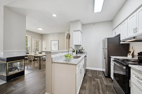 a kitchen with an island and a stove and a refrigerator