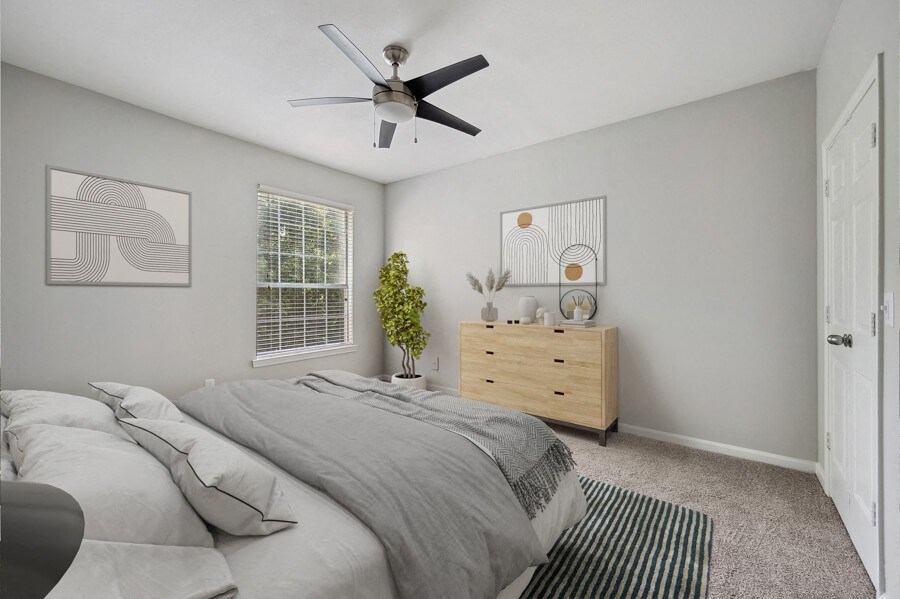 a bedroom with a large bed and a ceiling fan