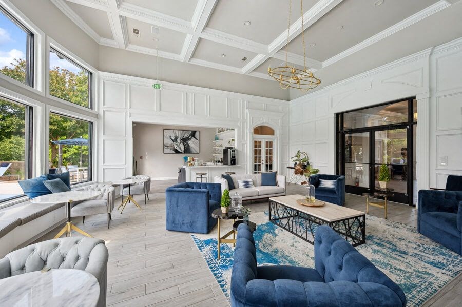 a living room with white walls and a coffered ceiling