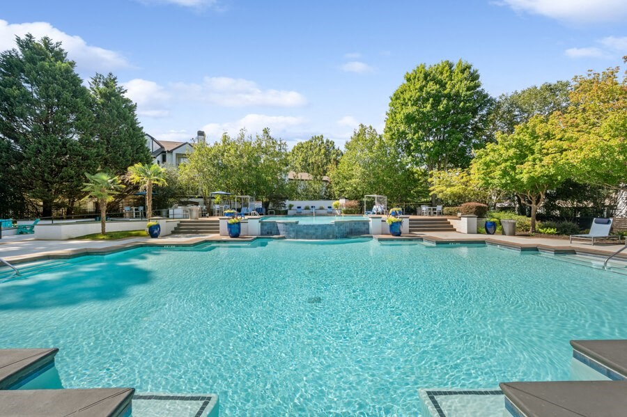 the preserve at ballantyne commons community pool and hot tub with trees in the background