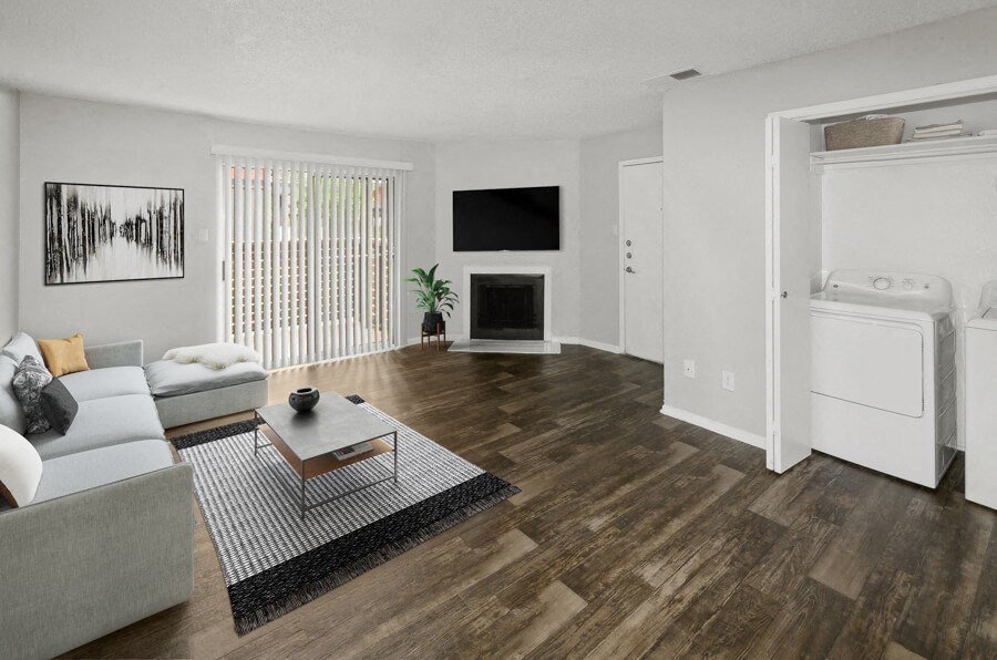 Model apartment living room with a couch and a table