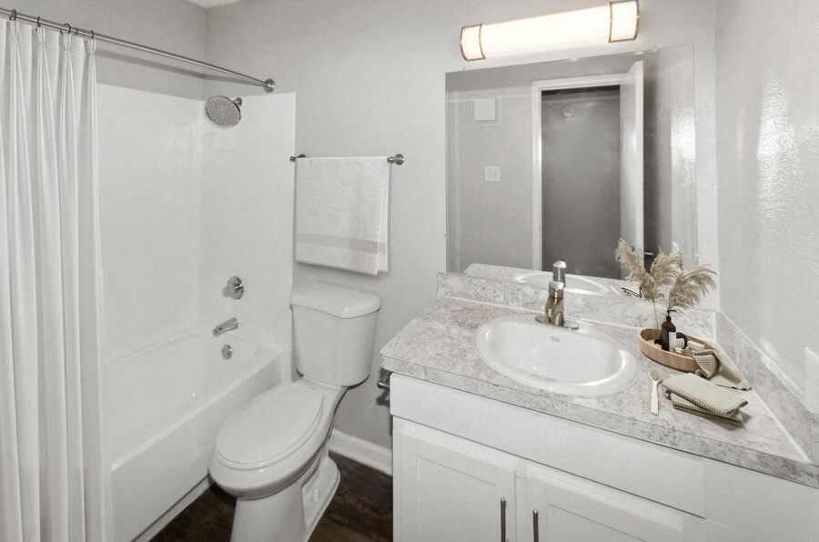 a white bathroom with a sink toilet and shower