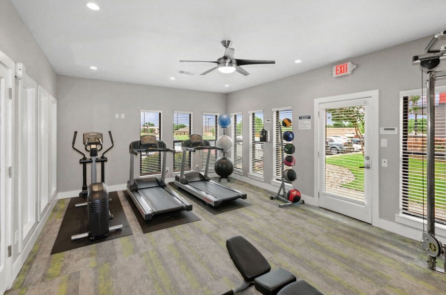 Community gym with treadmills and a ceiling fan