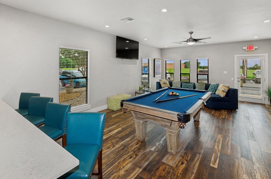 Community game room with a pool table and chairs