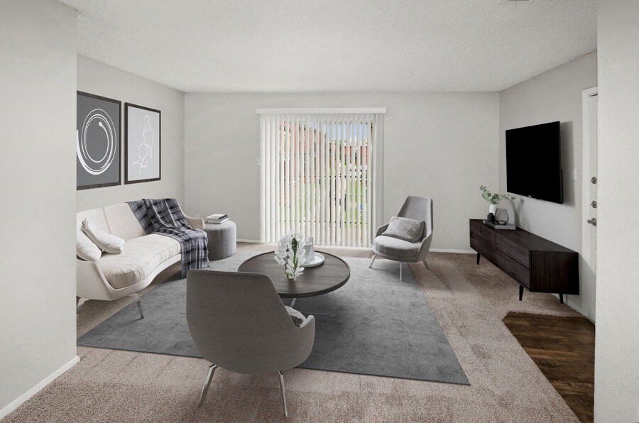 Model apartment living room with a couch and a table