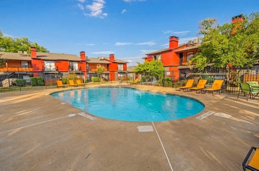Swimming pool with lounge chairs and cabanas.