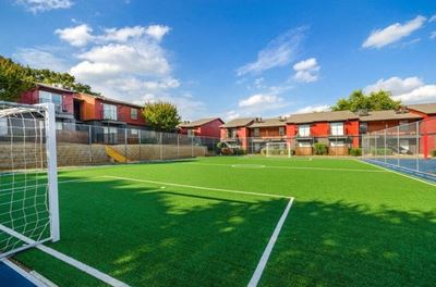 Soccer field with turf in between apartment buildings