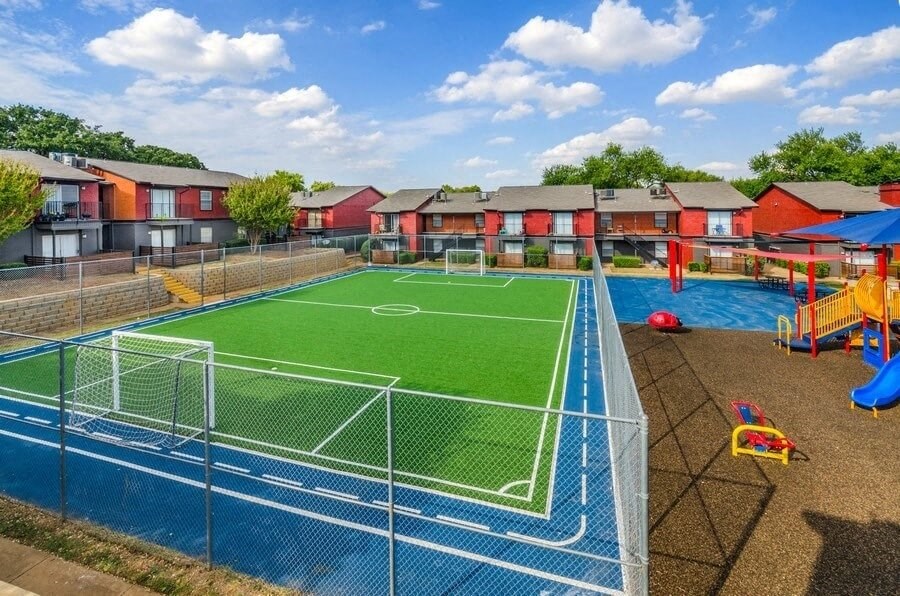 Fenced soccer field and playground  in a courtyard