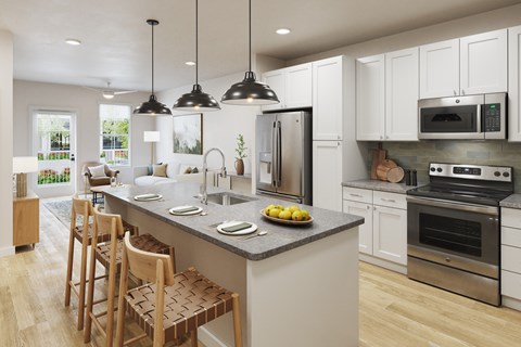 A modern kitchen with a large island and stainless steel appliances.