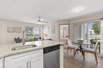 Model kitchen with bar and view of dining area - Photo Gallery 3