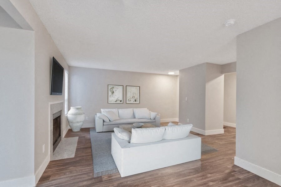 Furnished model living room with wood flooring