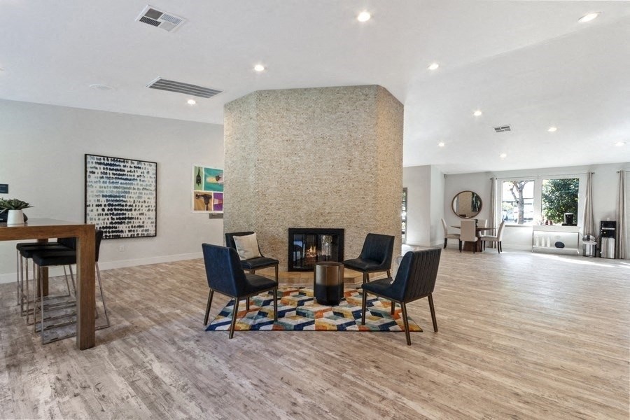 Clubhouse entrance with fireplace and chairs