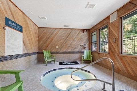 Hot Tub Spa Hot tub spa enclosed with wood panel walls and large windows.