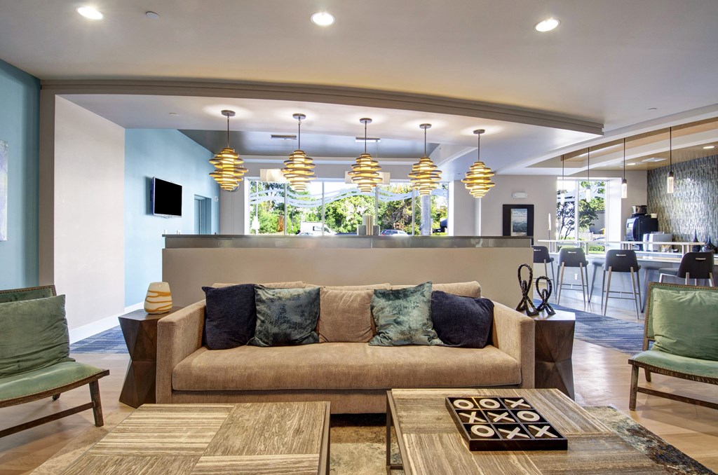 community center with a couch, chairs, and a rug.