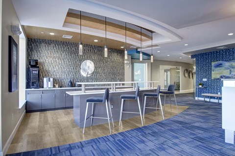 A modern kitchen with a bar area and a dining table.