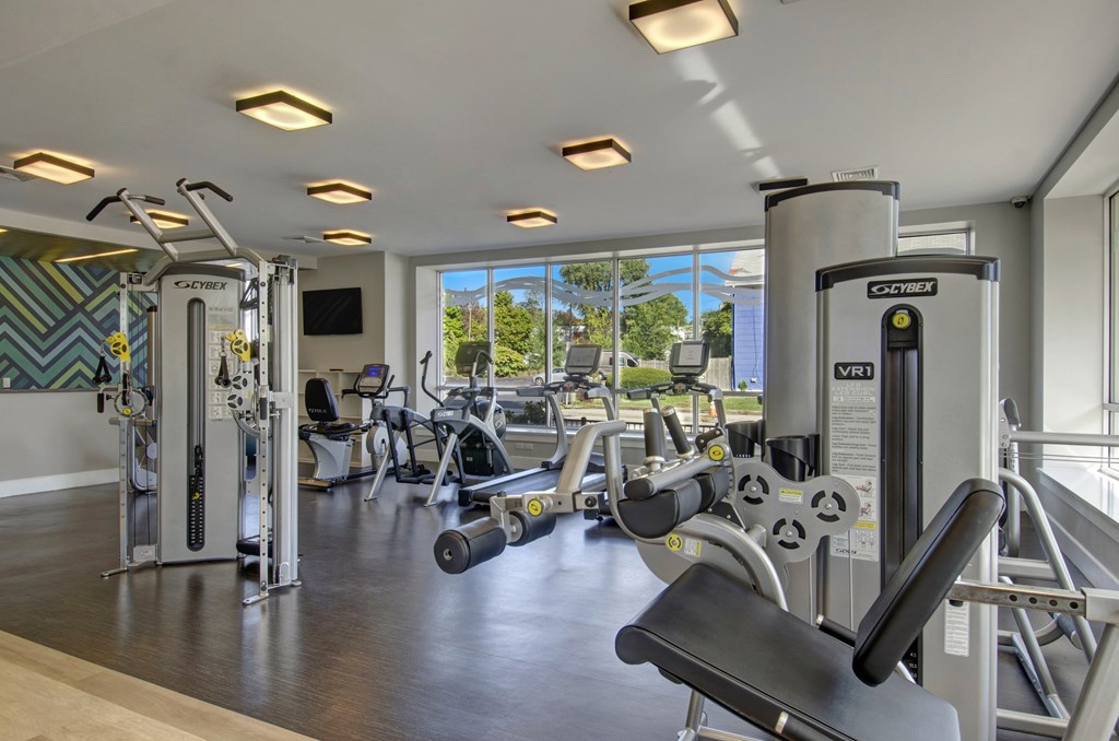 A gym with a variety of equipment including a leg press machine.