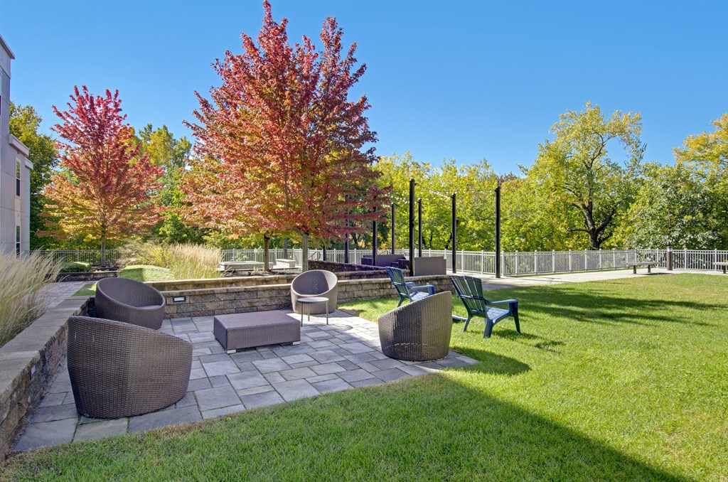 A beautiful outdoor seating area with a stone patio and comfortable chairs.