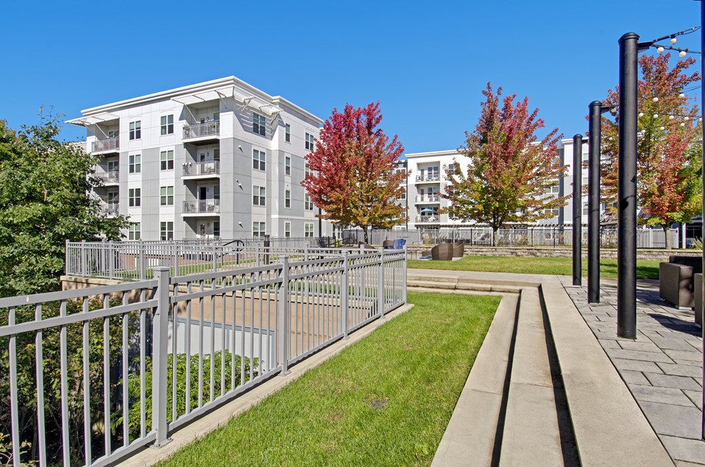 A grey building with a metal fence in front of it.