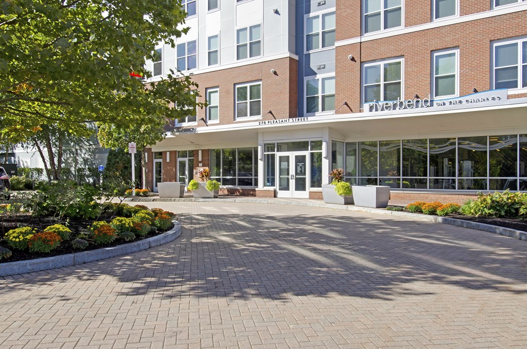 A brick building with a white awning and a sign that says