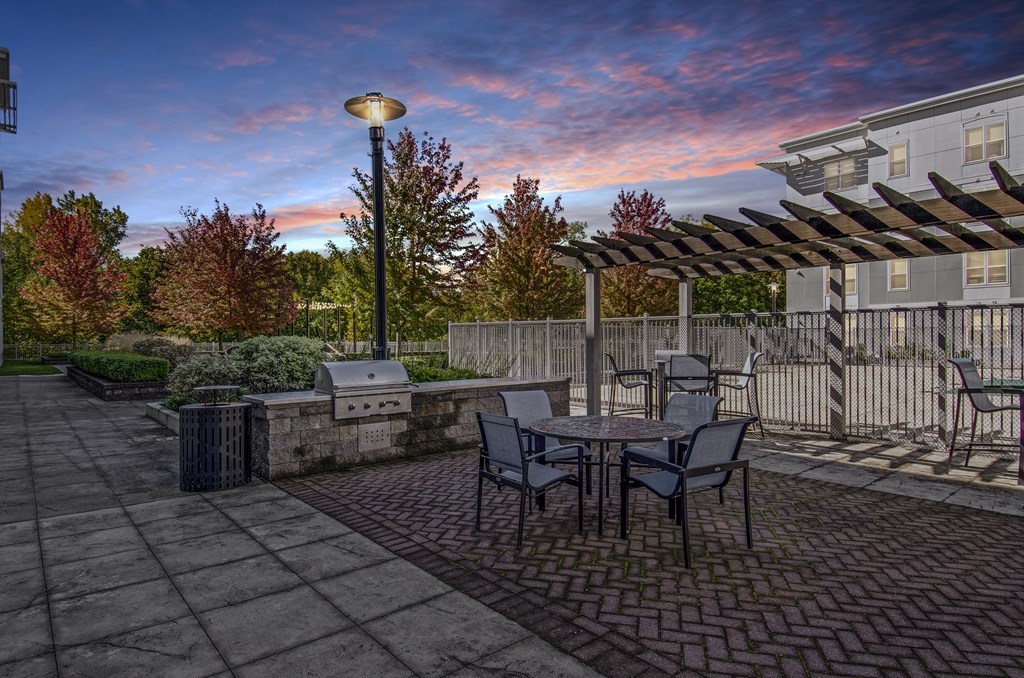 A patio with a table and chairs is set up for dining.
