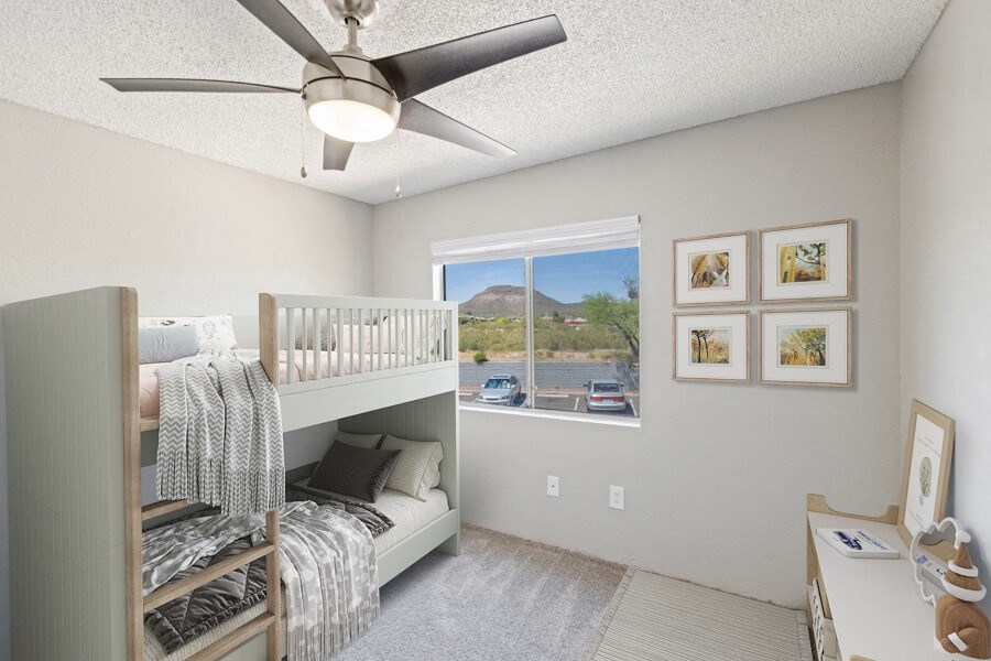 Model apartment bedroom with a bunk bed and a ceiling fan