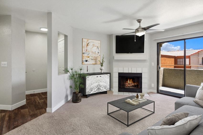 a living room with a fireplace and a flat screen tv - Photo Gallery 1