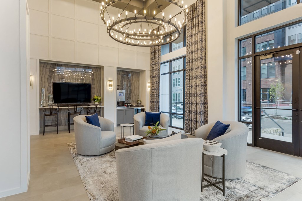 a living room filled with furniture and a large chandelier