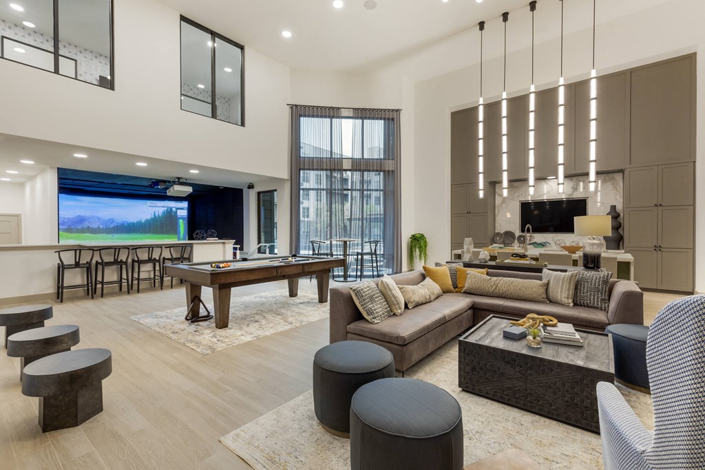 an open concept living room and dining room with a pool table and foosball table