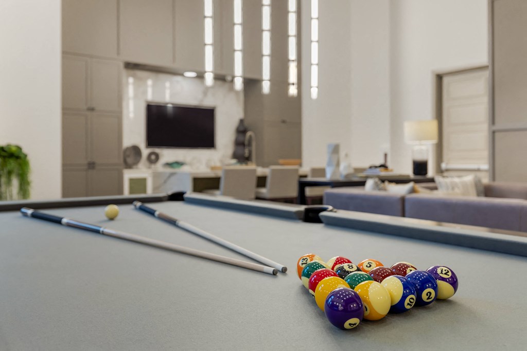 a games room with a pool table and a television