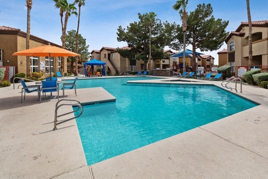 Swimming pool courtyard with palm trees and cabanas