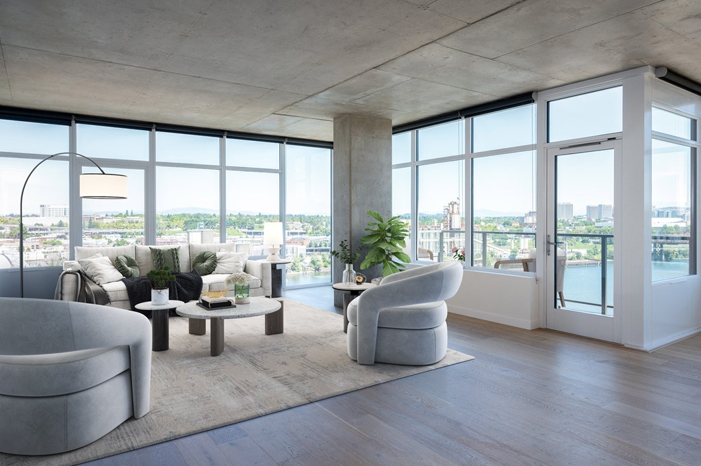 a living room with couches and chairs and a view of the city