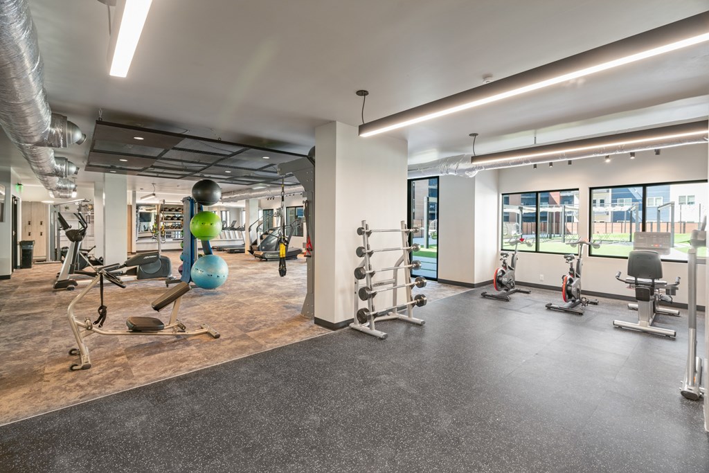 A gym with a variety of exercise equipment.