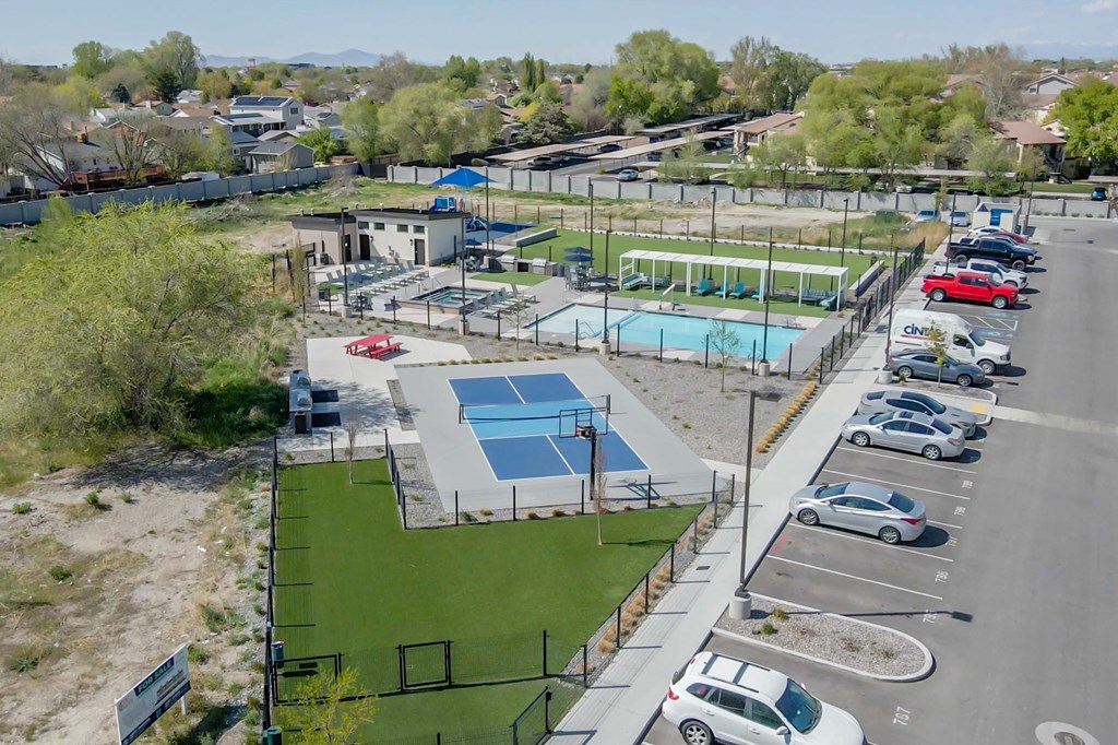 A park with a basketball court, a tennis court, and a swimming pool.